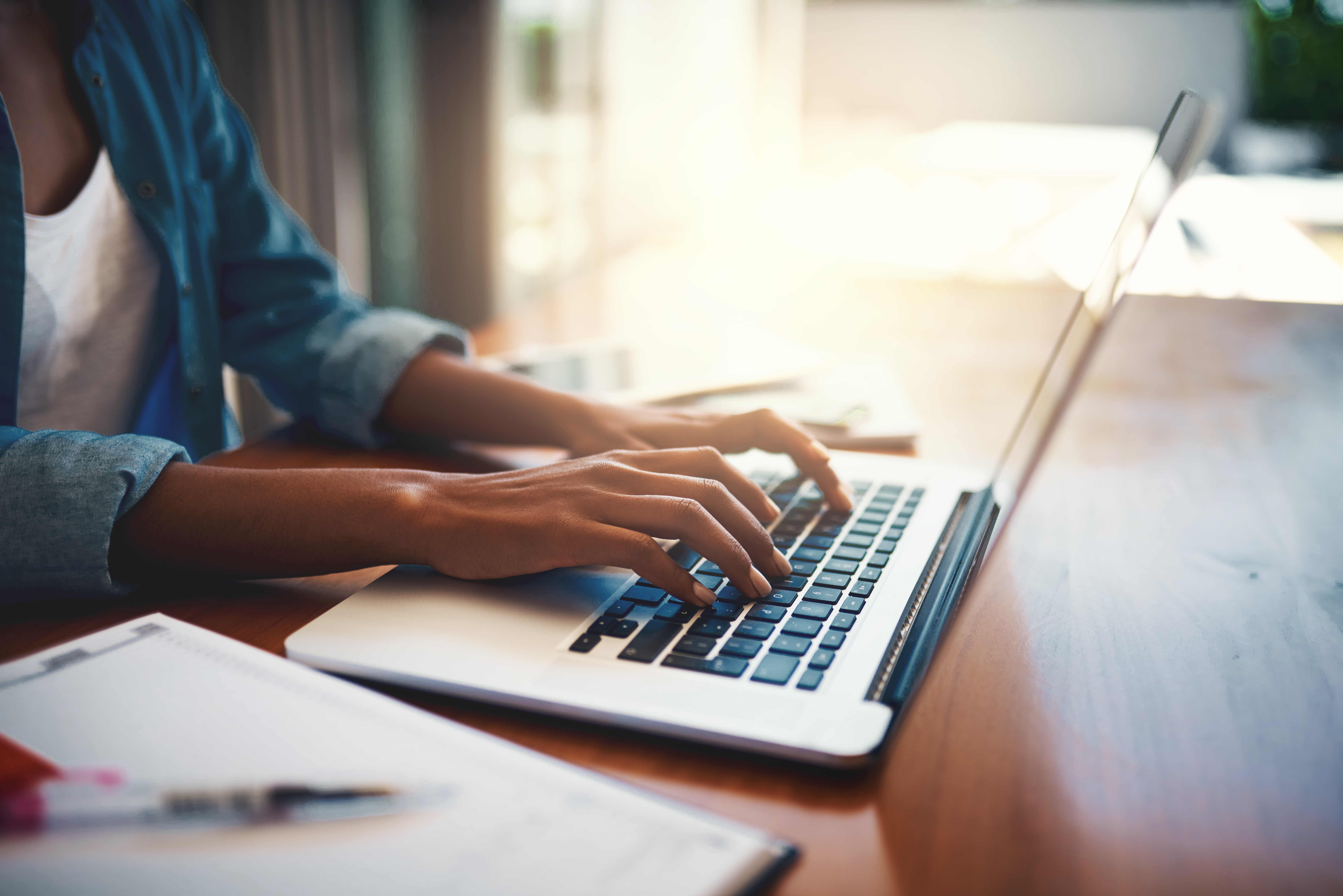 Woman typing at keyboard